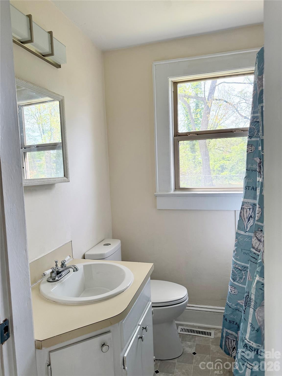 2025 28th Street Northeast Hickory, NC 28601 - Photo 12 of 17 a bathroom with a toilet sink vanity and mirror