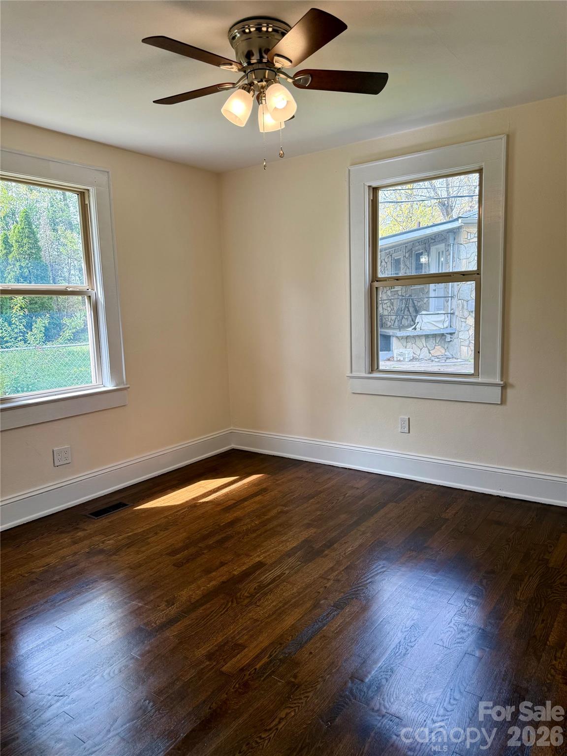 2025 28th Street Northeast Hickory, NC 28601 - Photo 7 of 17 a view of an empty room with wooden floor and a window