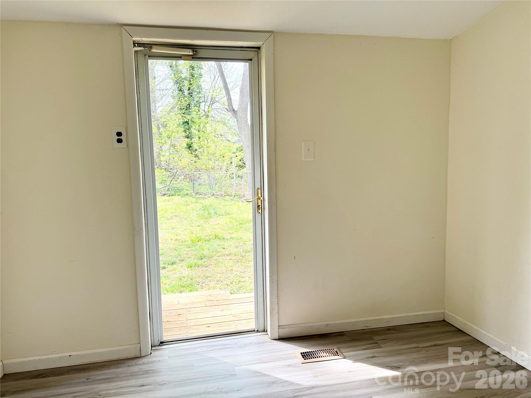 2025 28th Street Northeast Hickory, NC 28601 - Photo 8 of 17 a view of an empty room with wooden floor and a window