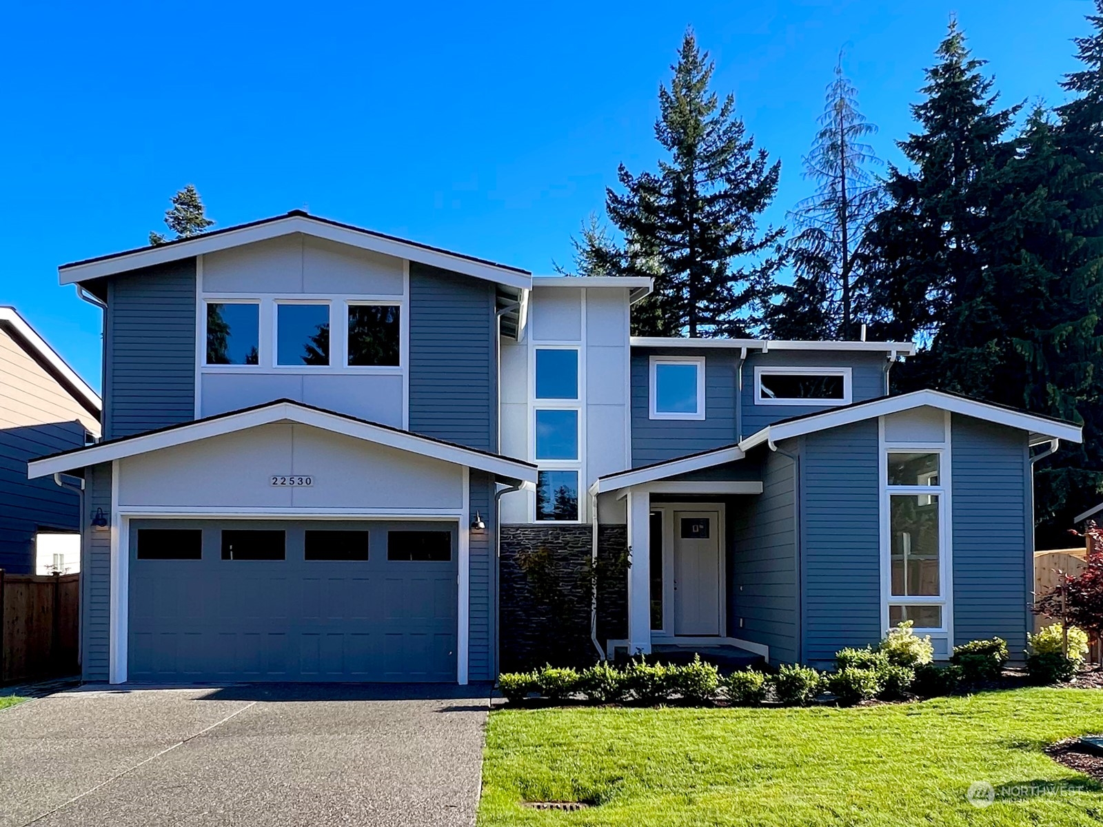 22530 Meridian Avenue South Bothell, WA 98021 - Photo 1 of 35 a front view of a house with a yard and garage