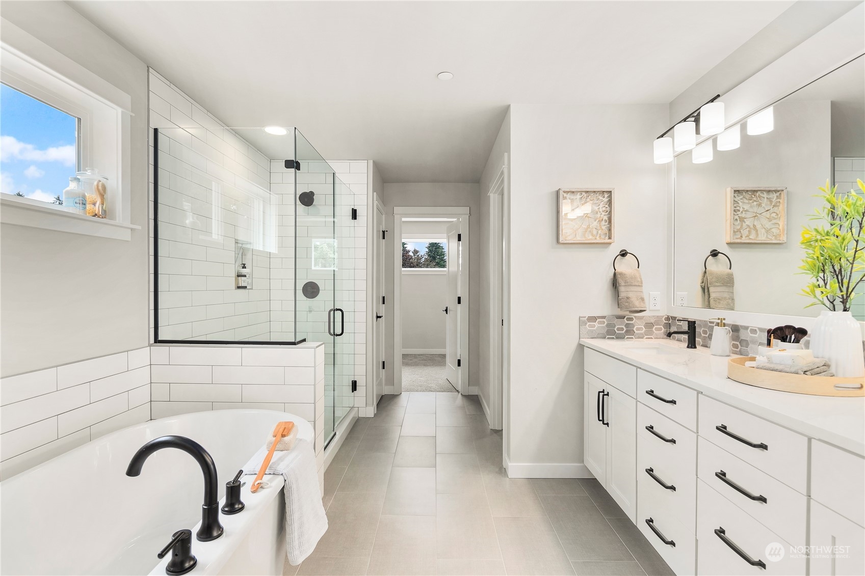 22530 Meridian Avenue South Bothell, WA 98021 - Photo 23 of 35 a spacious bathroom with a double vanity sink a mirror a shower and a bathtub