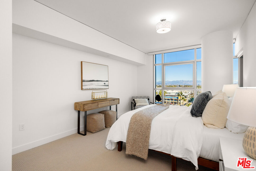 13650 Marina Pointe Drive, Unit 908 Marina del Rey, CA 90292 - Photo 14 of 33 a bedroom with a bed and a lamp on table