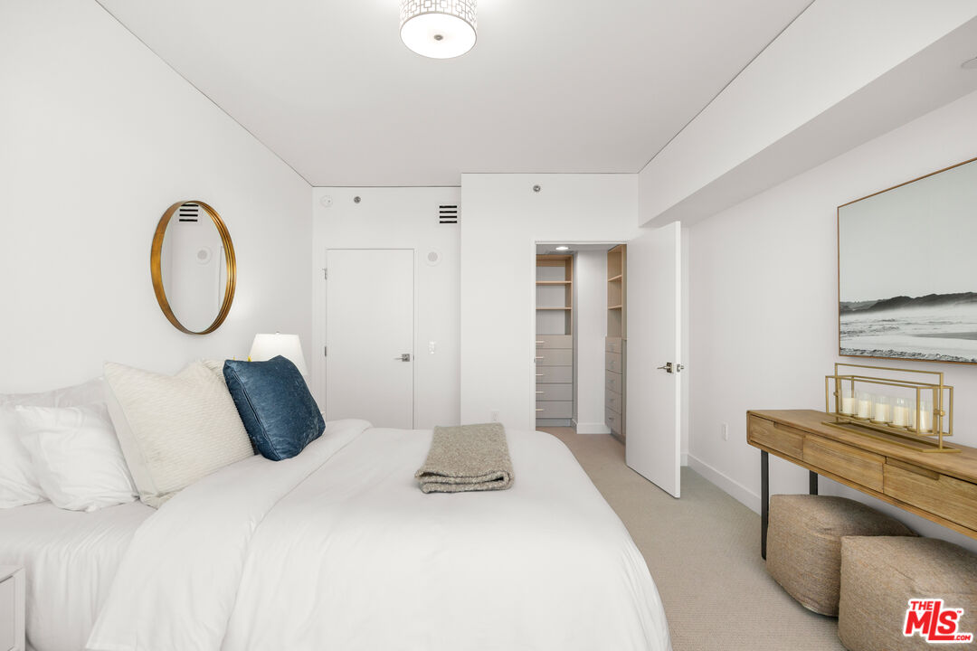 13650 Marina Pointe Drive, Unit 908 Marina del Rey, CA 90292 - Photo 15 of 33 a bedroom with a bed and a chandelier