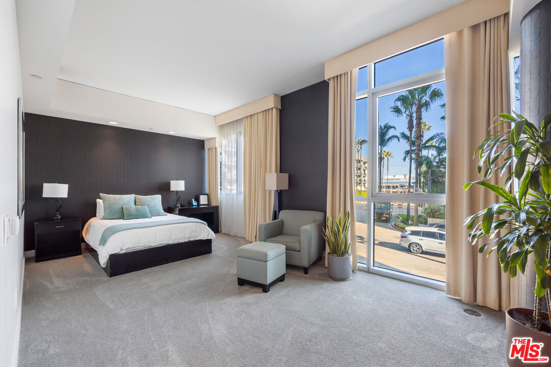 13650 Marina Pointe Drive, Unit 908 Marina del Rey, CA 90292 - Photo 20 of 33 a spacious bedroom with a bed and a large window