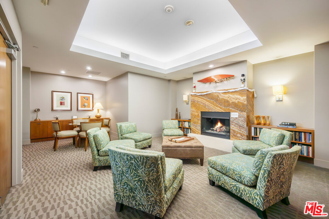 13650 Marina Pointe Drive, Unit 908 Marina del Rey, CA 90292 - Photo 24 of 33 a living room with furniture and a fireplace