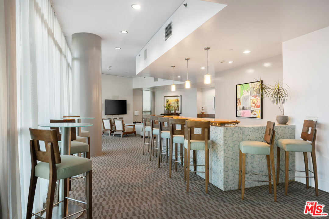 13650 Marina Pointe Drive, Unit 908 Marina del Rey, CA 90292 - Photo 25 of 33 a living room with lots of furniture and a wooden floor