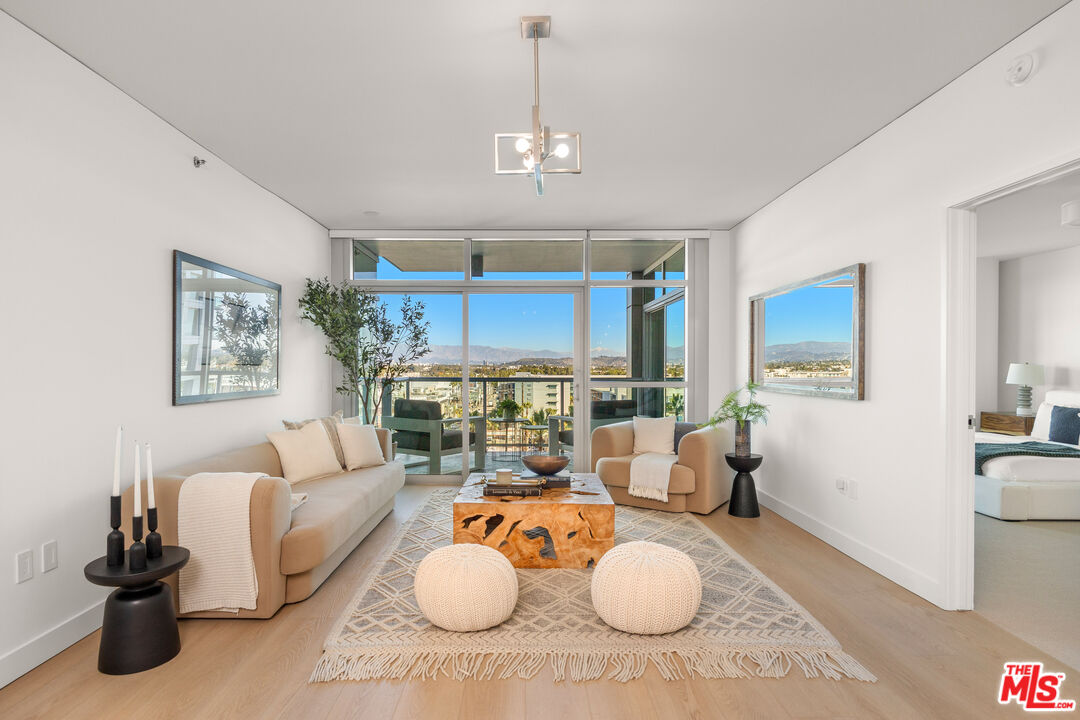 13650 Marina Pointe Drive, Unit 908 Marina del Rey, CA 90292 - Photo 3 of 33 a living room with furniture and a wooden floor