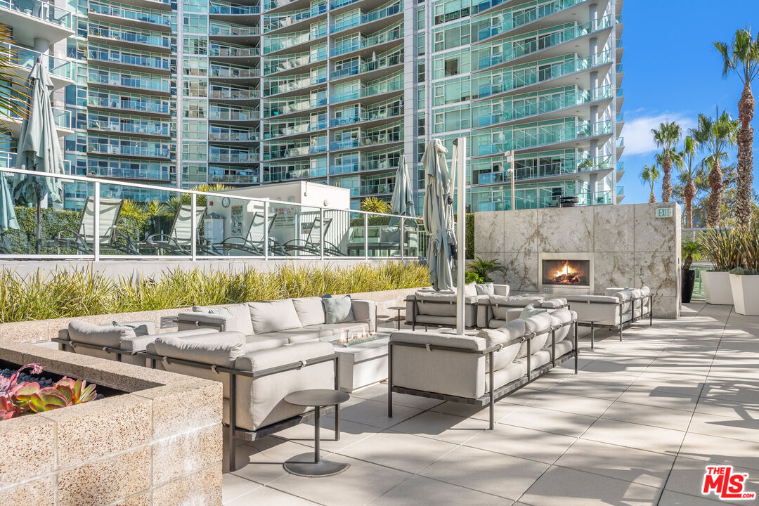 13650 Marina Pointe Drive, Unit 908 Marina del Rey, CA 90292 - Photo 31 of 33 a view of a patio with couches and dining table with garden view