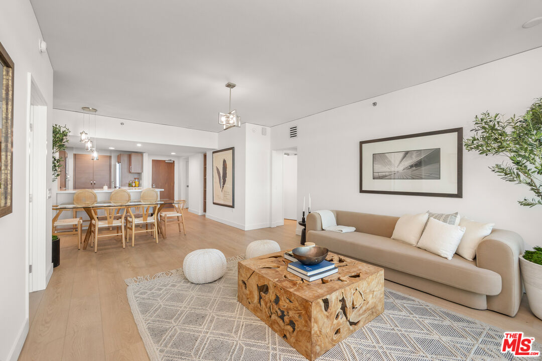 13650 Marina Pointe Drive, Unit 908 Marina del Rey, CA 90292 - Photo 4 of 33 a living room with furniture a rug and kitchen view