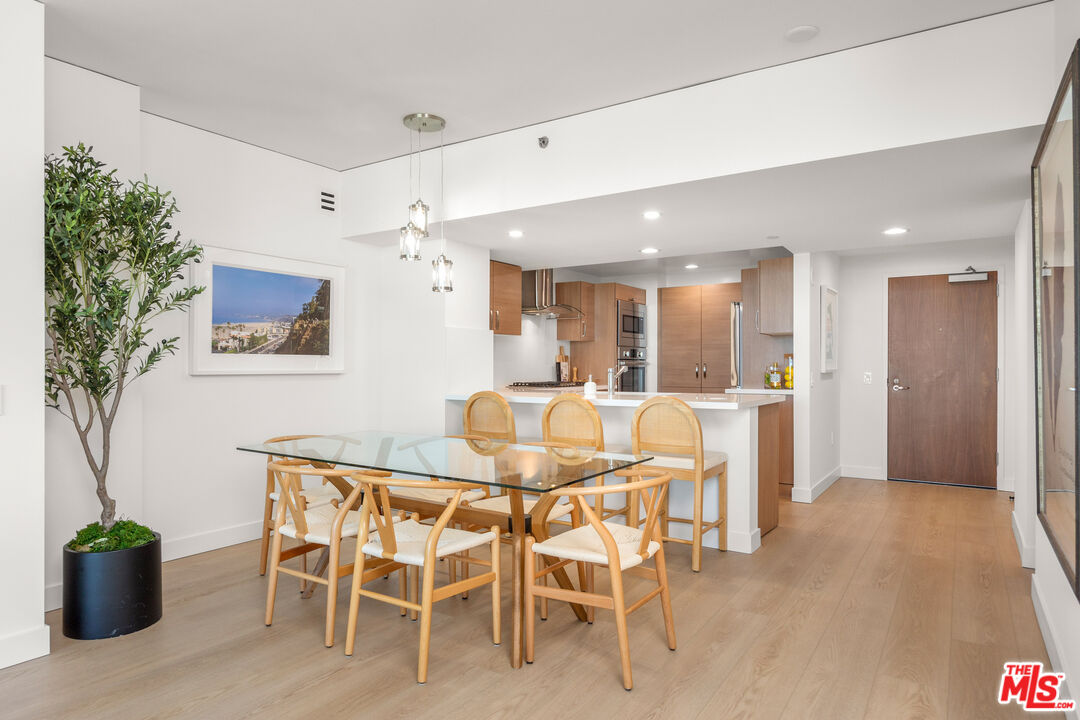 13650 Marina Pointe Drive, Unit 908 Marina del Rey, CA 90292 - Photo 5 of 33 a view of a dining room with furniture and a potted plant