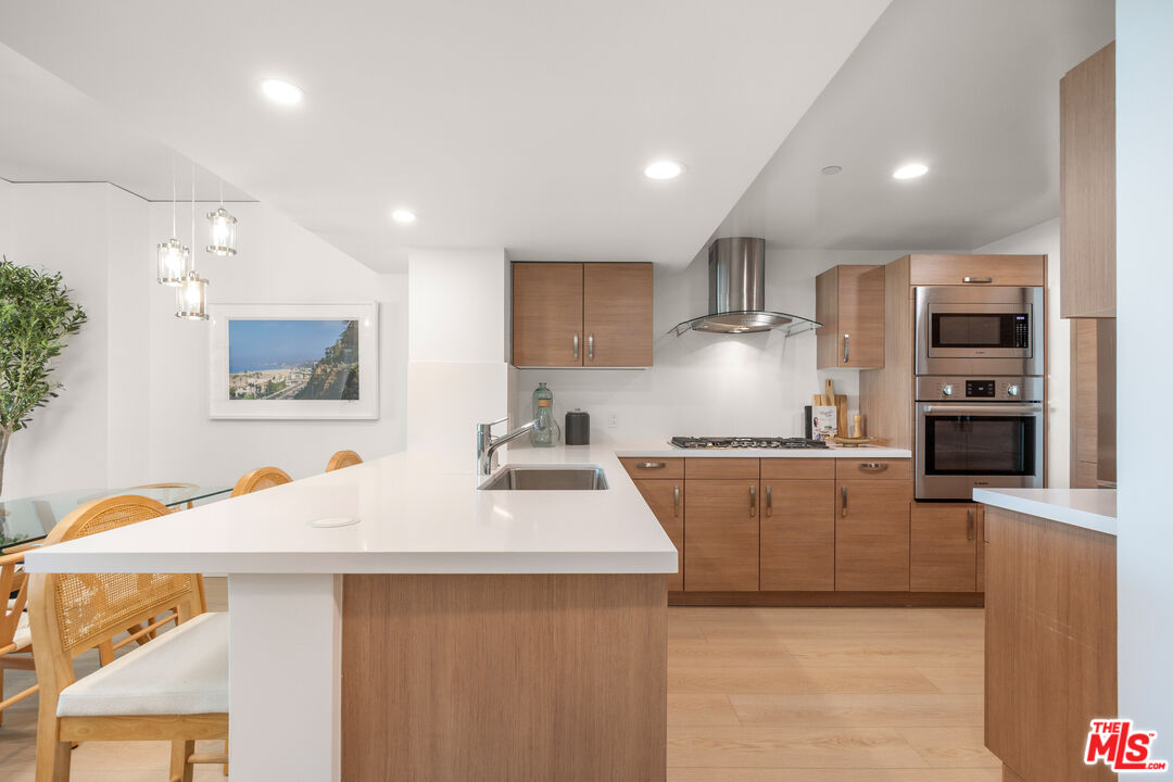 13650 Marina Pointe Drive, Unit 908 Marina del Rey, CA 90292 - Photo 6 of 33 a kitchen with stainless steel appliances a sink stove and refrigerator