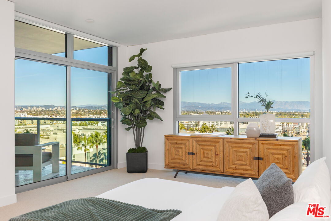 13650 Marina Pointe Drive, Unit 908 Marina del Rey, CA 90292 - Photo 9 of 33 a bedroom with furniture and large windows