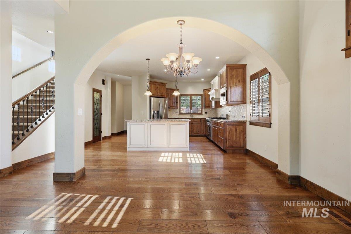 129 East Cholla Hills Street Meridian, ID 83646 - Photo 24 of 33 Carpeted room featuring a large sliding glass door, two windows with wood plantation shutters, and wood trim