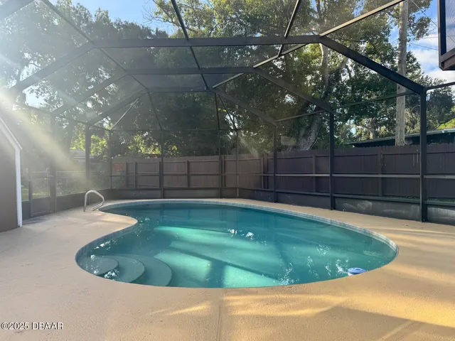 a view of a backyard with swimming pool