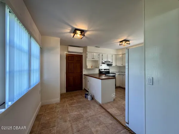 a kitchen with a refrigerator and cabinets
