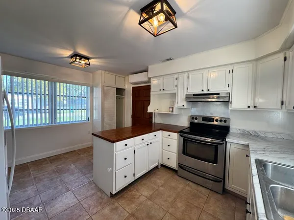 a kitchen with stainless steel appliances a stove a sink and a refrigerator