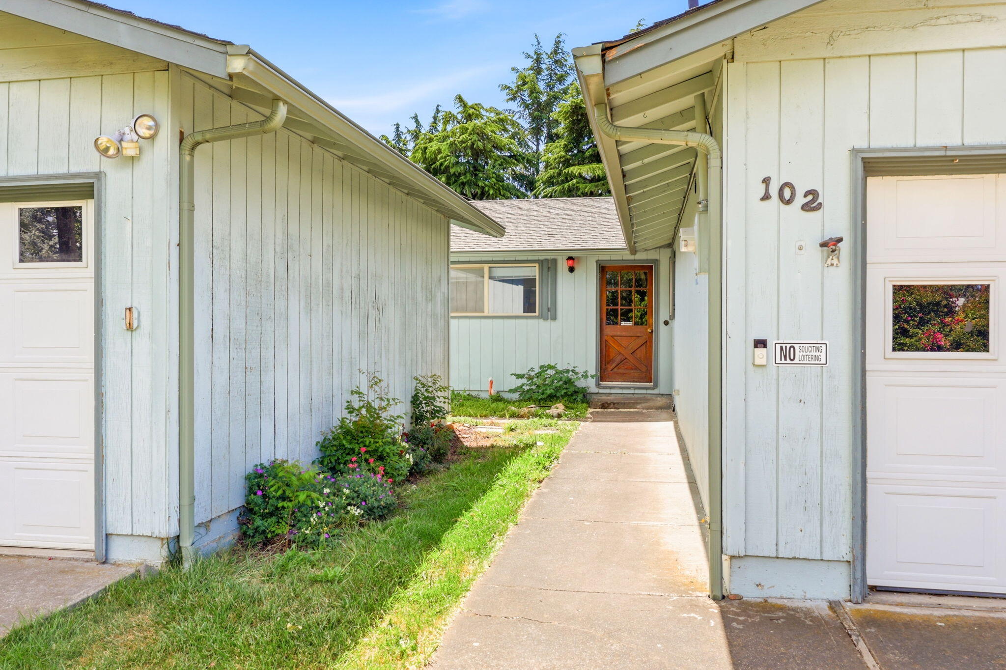 102 Elm Street Phoenix, OR 97535 - Photo 6 of 28 a front view of a house with garden