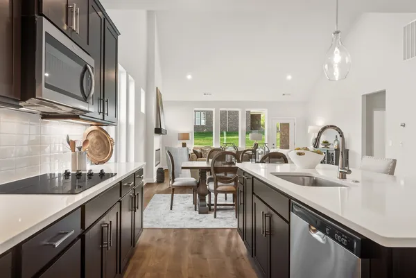 a kitchen with a sink stainless steel appliances and cabinets