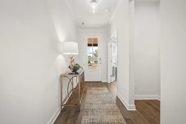 a view of a hallway with furniture