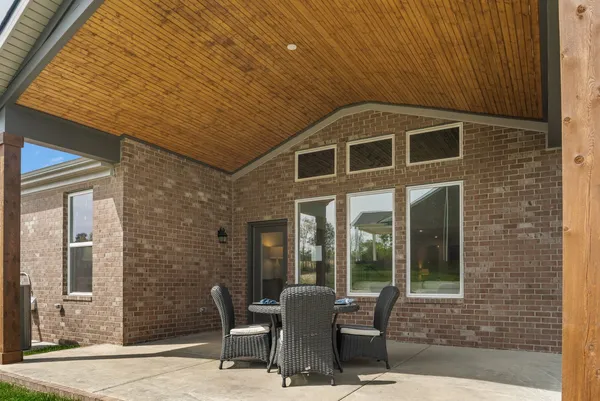 a view of a house with backyard porch and sitting area