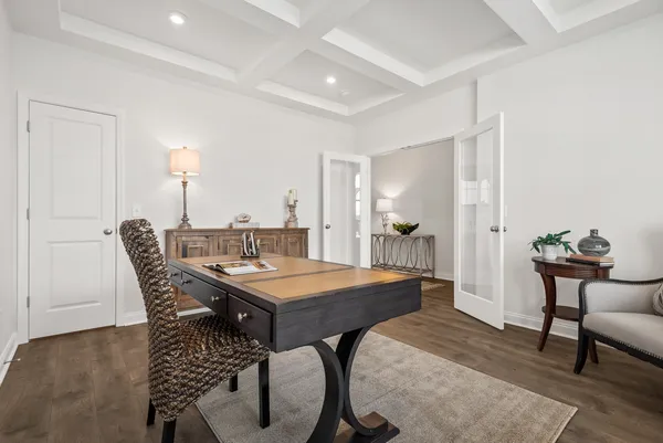 a dining room with furniture and wooden floor