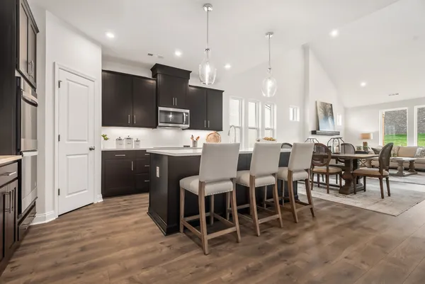 a large kitchen with a table and chairs