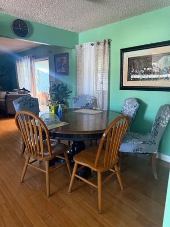 a view of a dining room with furniture wooden floor and a rug