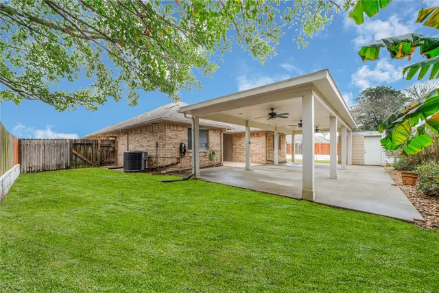 a front view of a house with a yard and garden