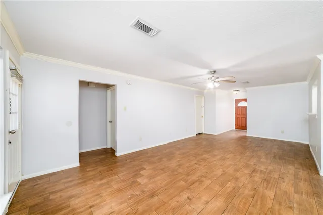a view of an empty room with a ceiling fan