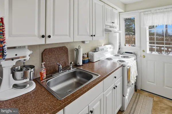 a kitchen with a sink stove and cabinets