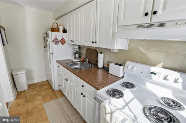 a kitchen with stainless steel appliances a stove a sink and a refrigerator