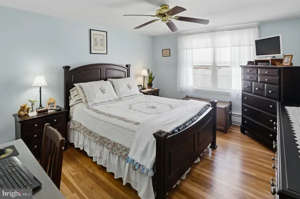 a spacious bedroom with a bed and a flat screen tv