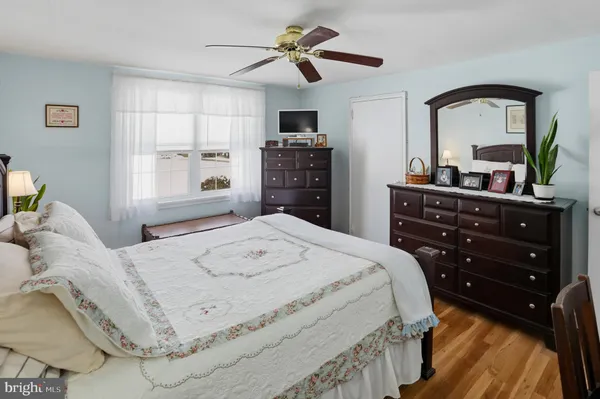 a bedroom with a bed a dresser and a large mirror