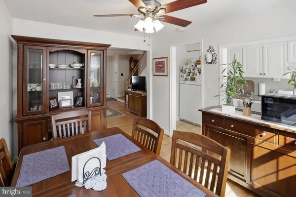 a living room with furniture dining table and wooden floor