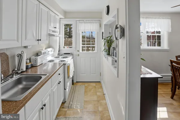a kitchen with a sink stove and refrigerator