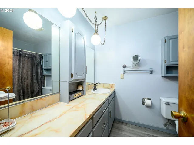 a bathroom with a sink a vanity and a mirror