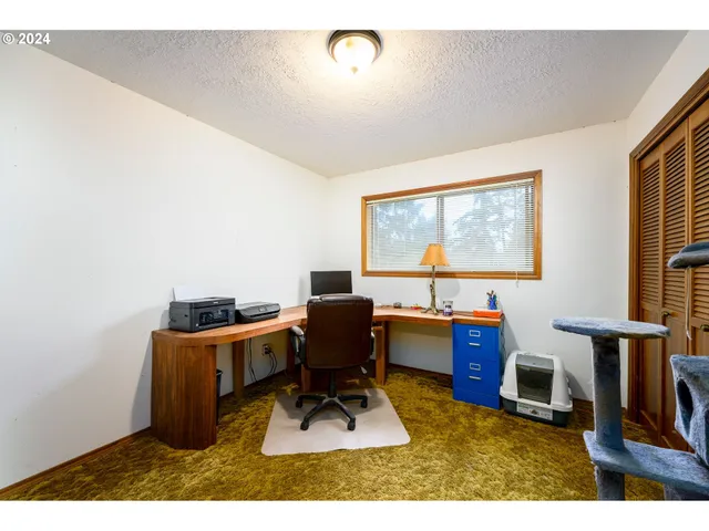 a work room with furniture and a window