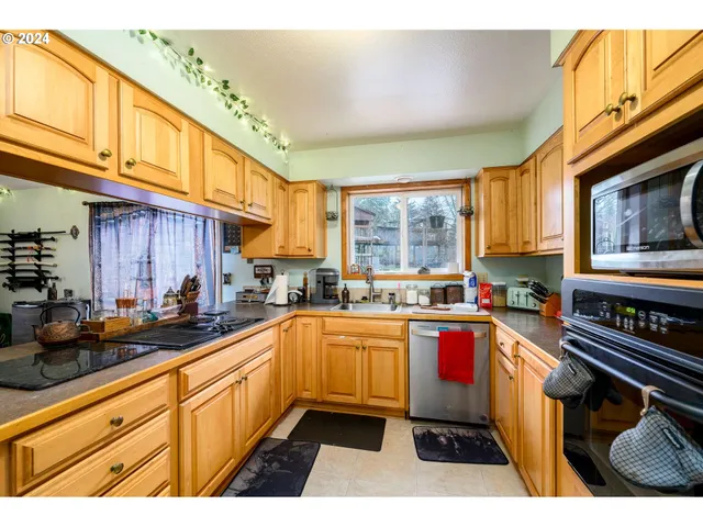 a kitchen with a sink stove top oven and microwave