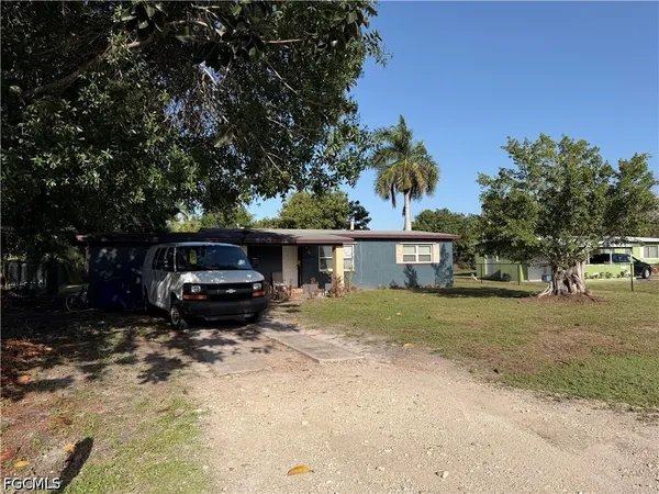 a view of a house with a truck parked in a yard