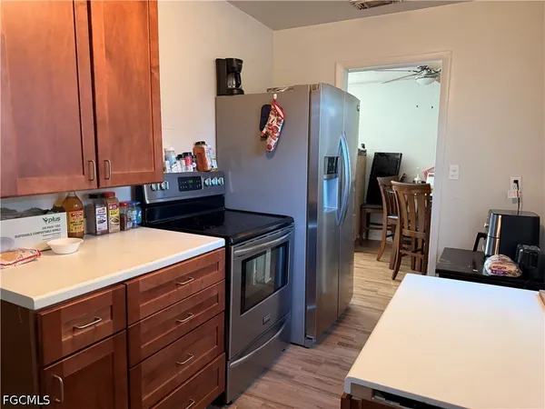 a kitchen with stainless steel appliances granite countertop a refrigerator and a stove