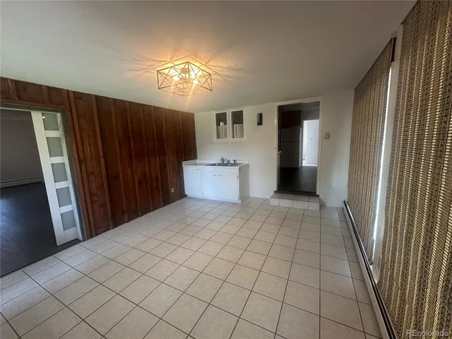 a kitchen with a refrigerator and cabinets