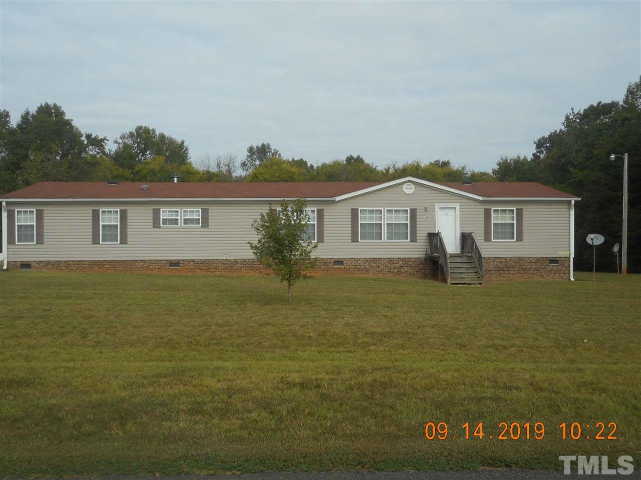 1335 Thomas Store Road Timberlake, NC 27583 - Photo 1 of 13 a front view of a house with garden