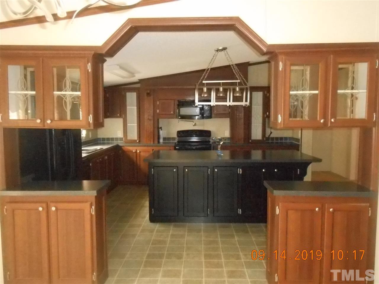 1335 Thomas Store Road Timberlake, NC 27583 - Photo 11 of 13 a kitchen with a refrigerator and a stove