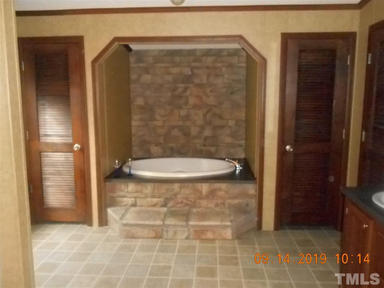 1335 Thomas Store Road Timberlake, NC 27583 - Photo 13 of 13 a bathroom with a glass shower door