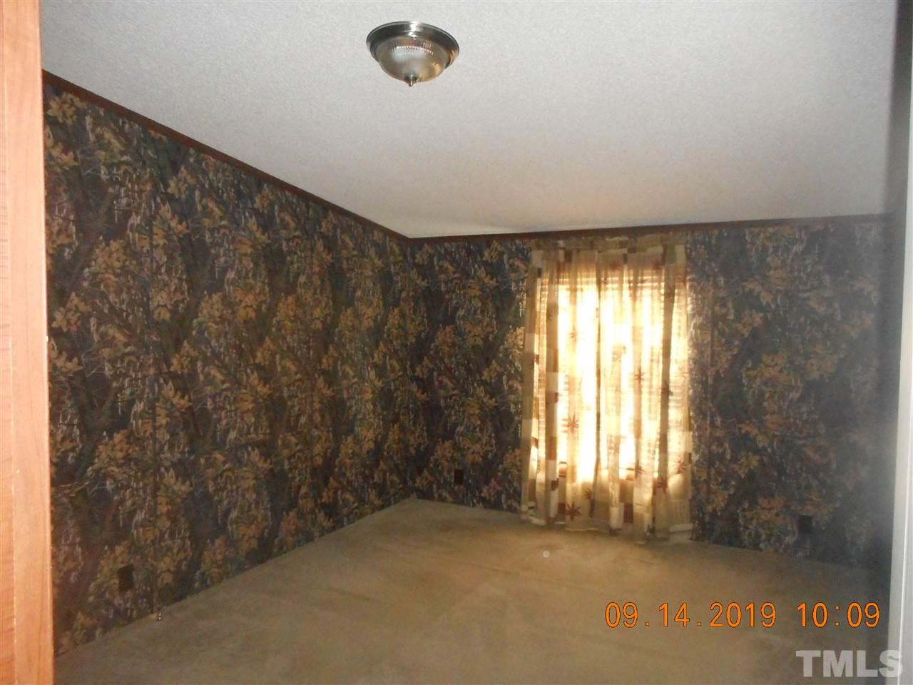 1335 Thomas Store Road Timberlake, NC 27583 - Photo 8 of 13 a view of an empty room and window