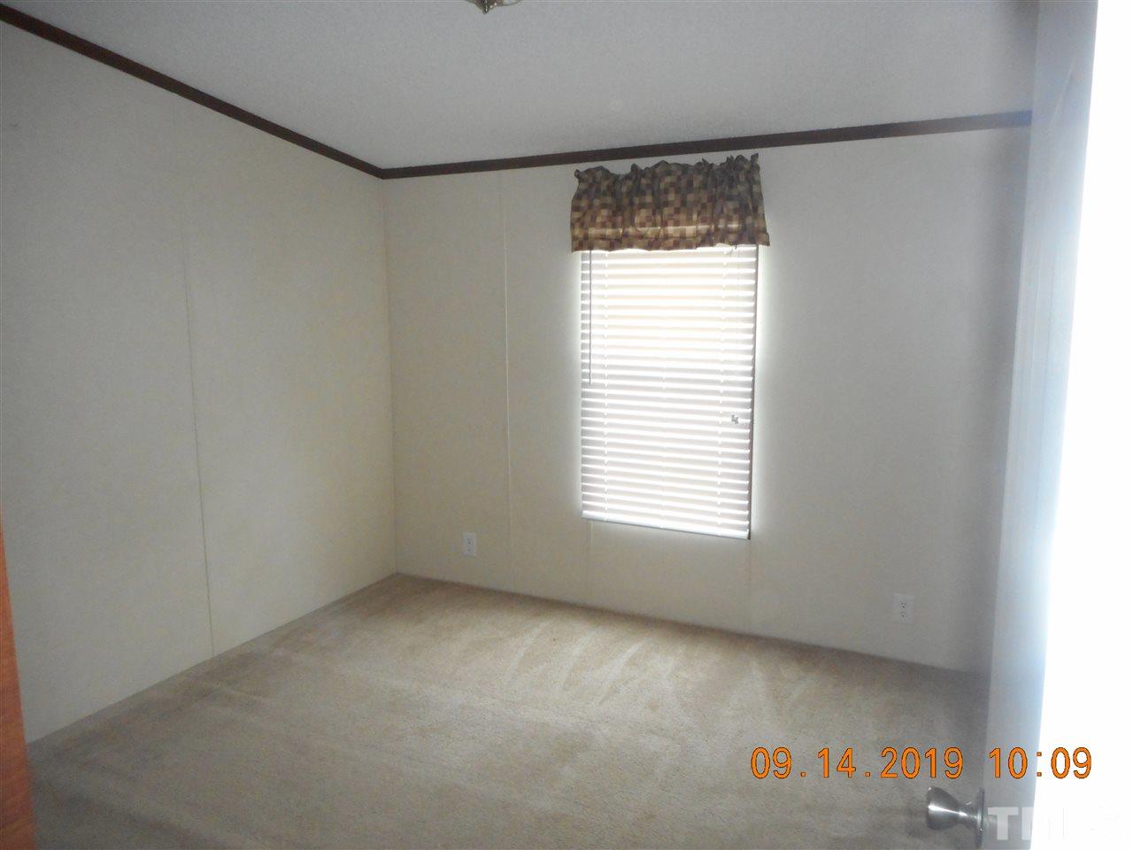 1335 Thomas Store Road Timberlake, NC 27583 - Photo 9 of 13 a view of an empty room with a window