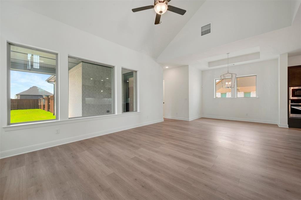 1908 Cola Drive Van Alstyne, TX 75495 - Photo 24 of 29 Spacious interior featuring wood-finish flooring, high vaulted ceilings, and a modern ceiling fan