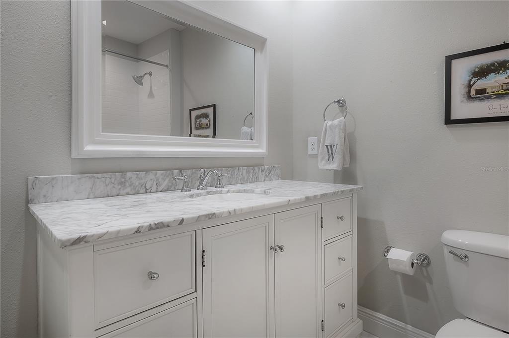 3108 West Villa Rosa Street Tampa, FL 33611 - Photo 33 of 58 a bathroom with a granite countertop sink and a mirror