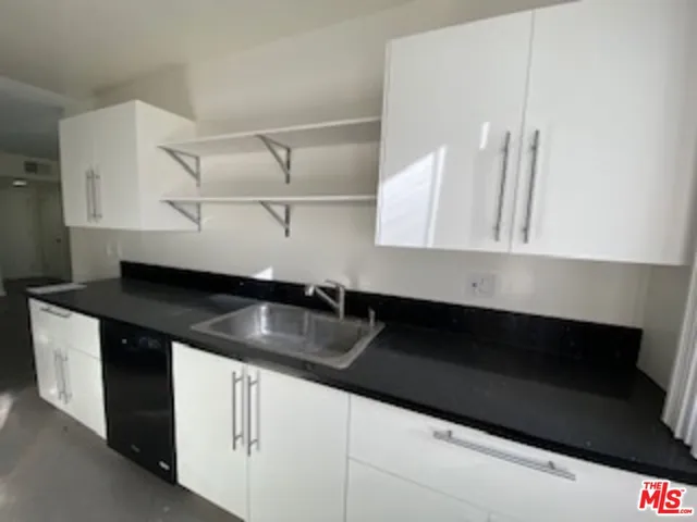 a kitchen with stainless steel appliances granite countertop a stove a refrigerator and a microwave