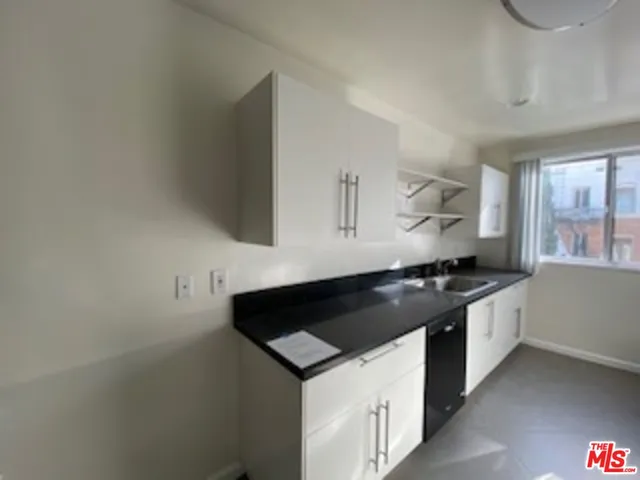 a kitchen with stainless steel appliances a refrigerator sink and cabinets